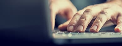 IT security solutions - close up of hands on a keyboard
