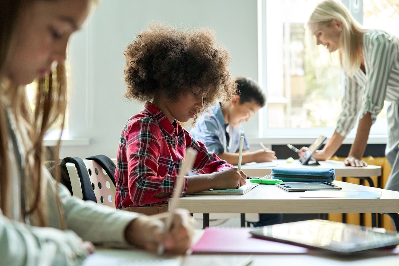 children using technology for education solutions in a classroom at school
