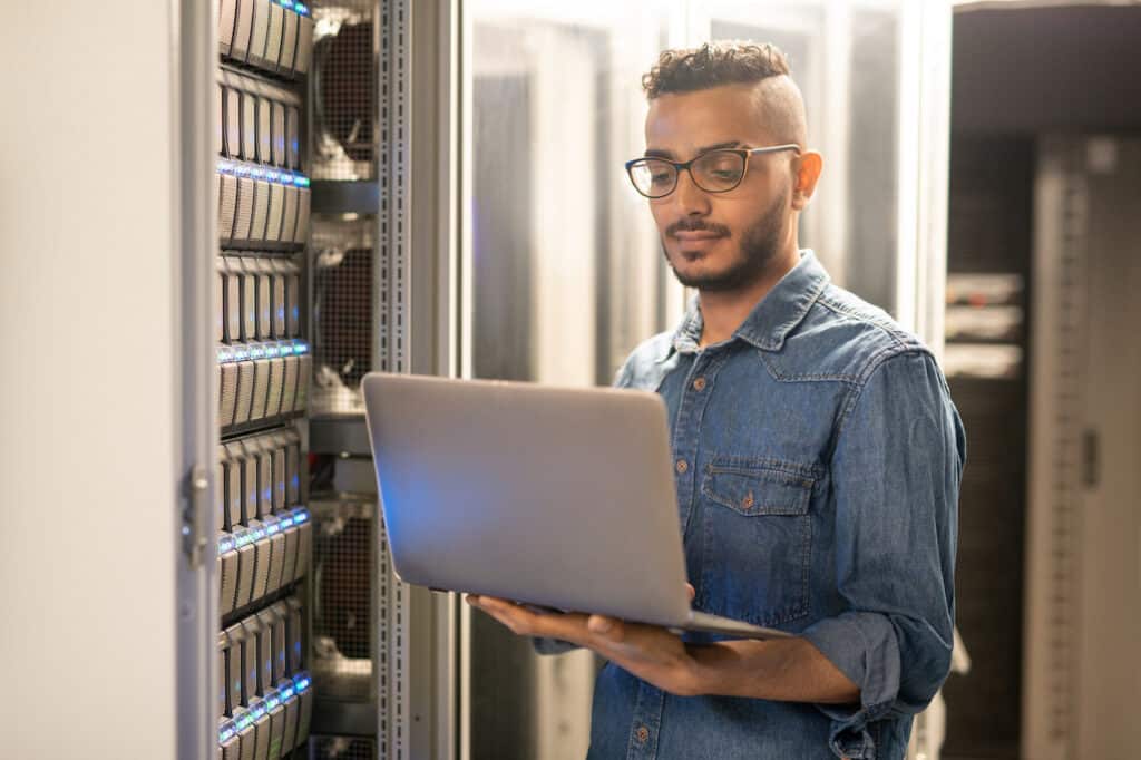 male it support technician working in server room