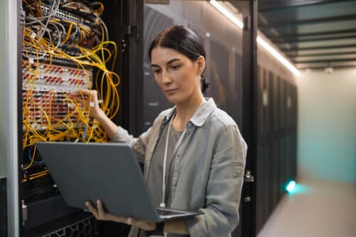 female network technician setting up data with disaster recovery services