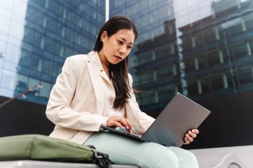 young female business professional getting assistance from IT services on her laptop