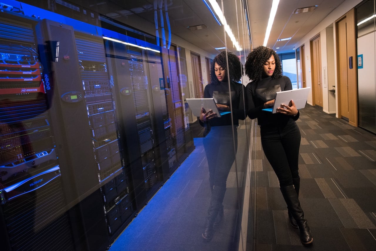 it company services professional working in server room hallway