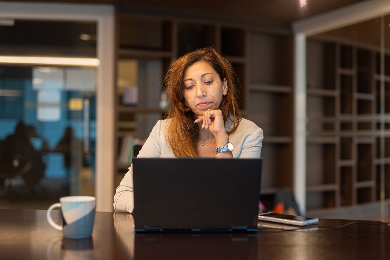 woman at work on computer reviewing cybersecurity checklist