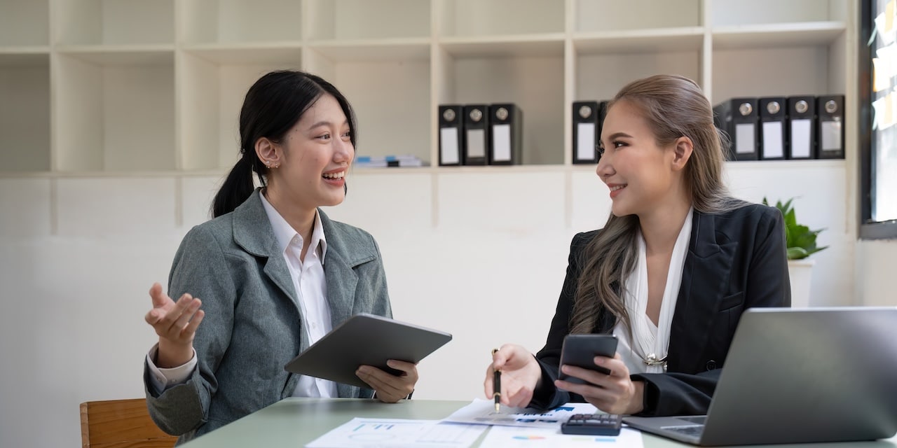 business associates at desk strategizing plans