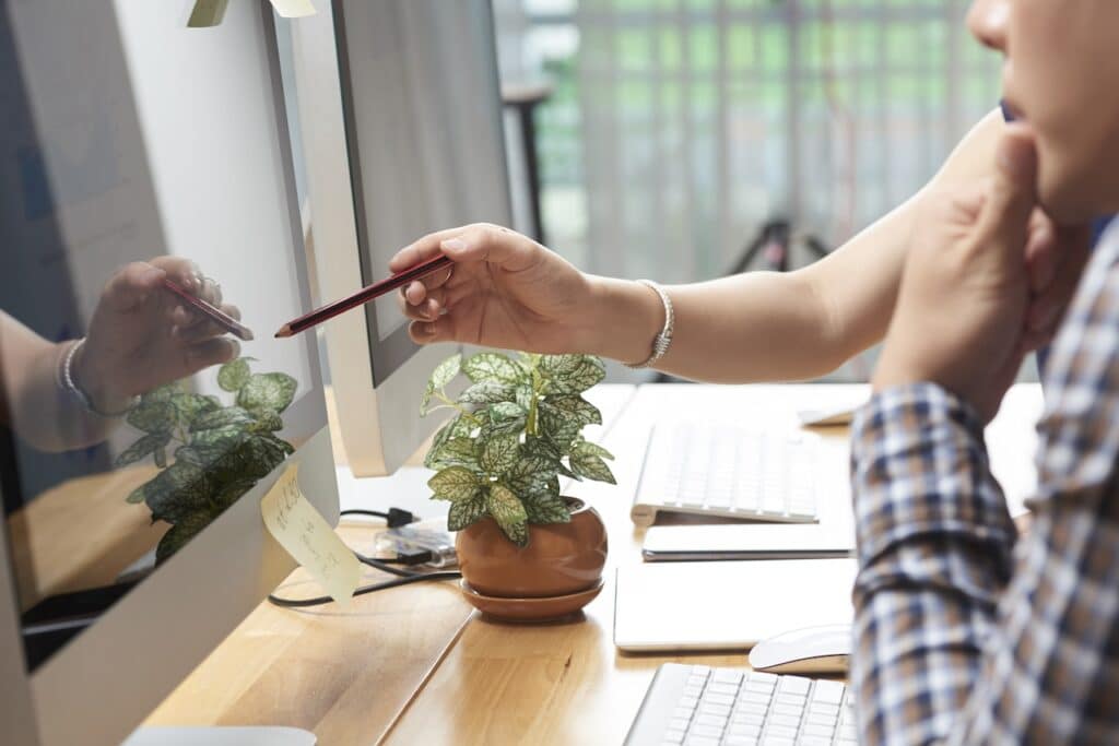 coworkers at desk working on business computing solutions
