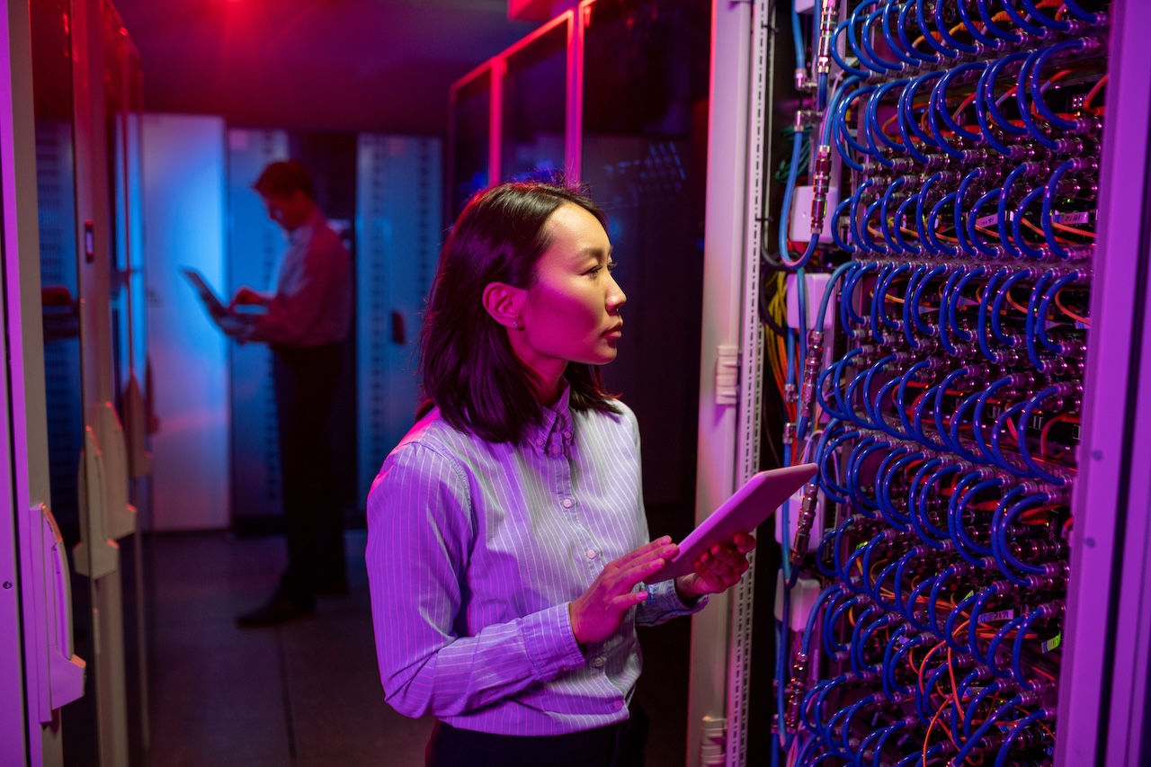 female managed computer services professional maintaining network in server room